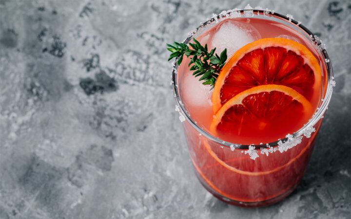 Blood Orange Margarita coctail with ice and thyme