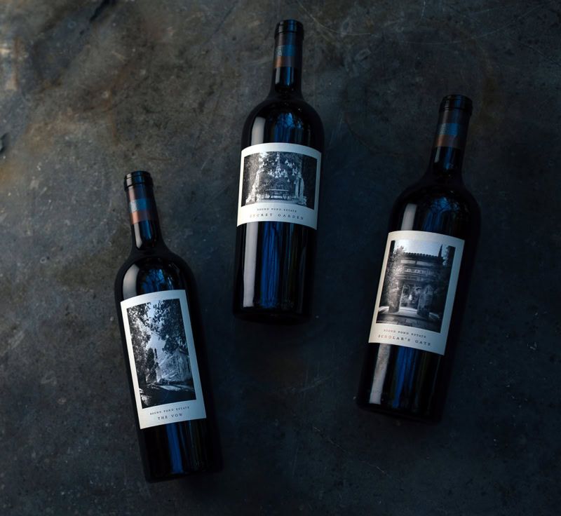 Three bottles of wine from Round Pond Estate on a dark surface.