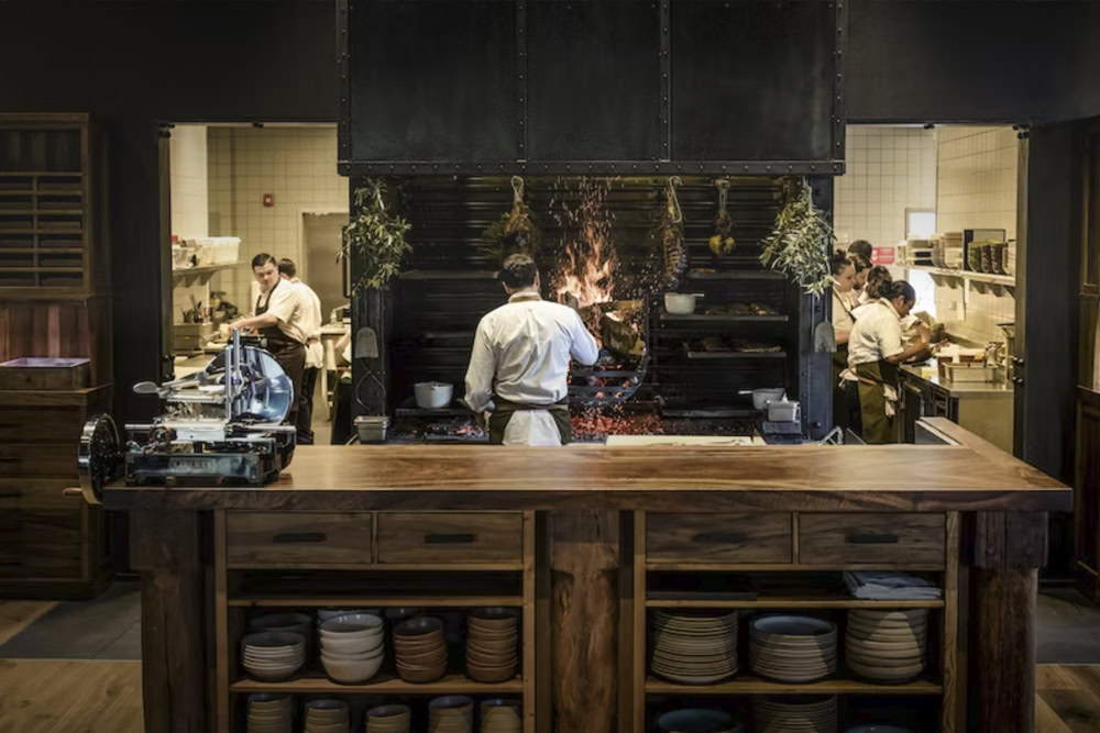 A bustling kitchen at Round Pond Estate with chefs preparing dishes in a professional setting.