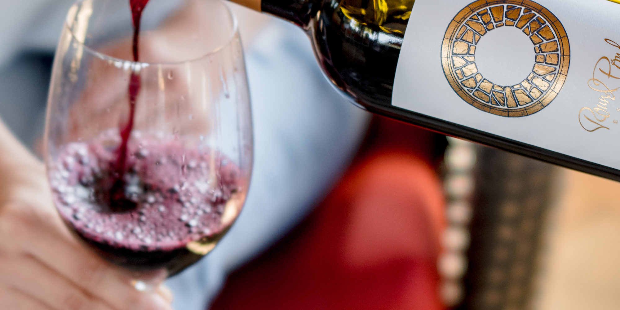 Wine being poured into a glass at a restaurant