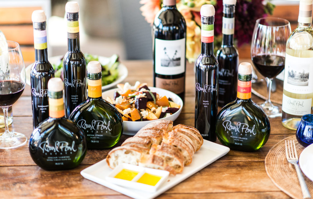 Tablescape with Round Pond olive oil, wine, bread and more