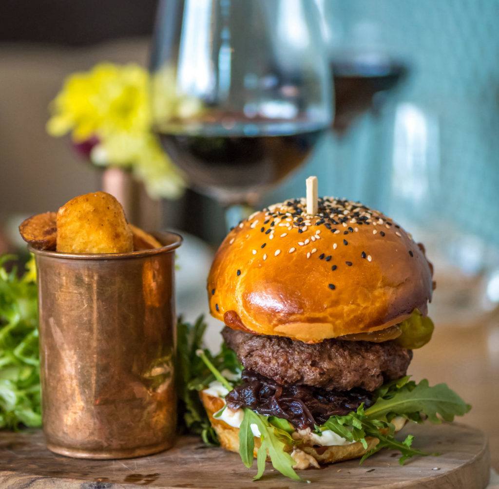 Cheeseburger with glass of red wine