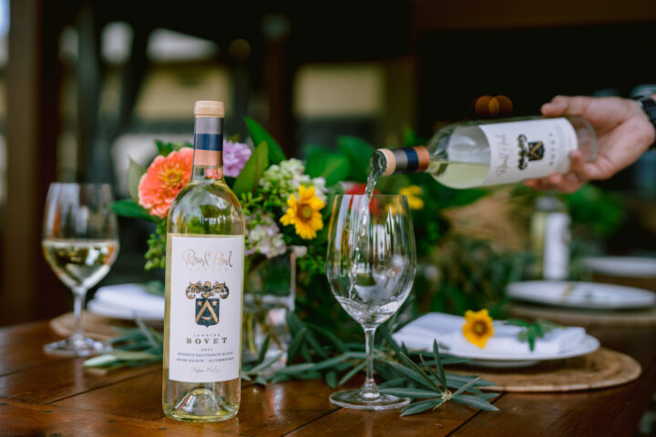 Jannine Bovet Sauvignon Blanc on the table and being poured into a wine glass