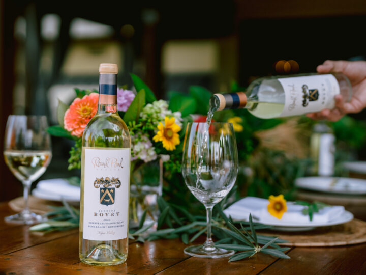 Jannine Bovet Sauvignon Blanc on the table and being poured into a wine glass