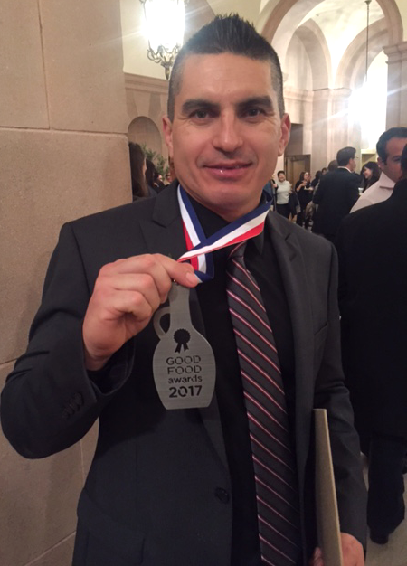 Man wearing a suit and medal at Round Pond Estate during Sustainability Series Part I: People event.