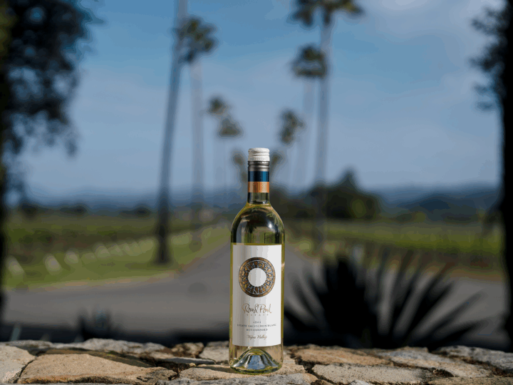 Bottle of Sauvignon Blanc staged in front of Round Pond's Palm Drive