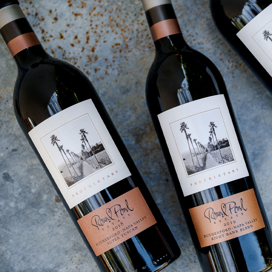 Two bottles of Round Pond Estate wine from Rutherford, Napa Valley, with labels showing palm trees and vineyard scenes.