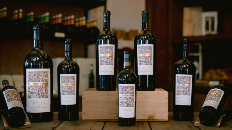 Five bottles of Cabernet Sauvignon from Round Pond Estate displayed on a wooden surface.