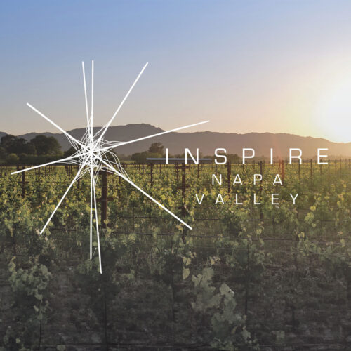 Sunset over a vineyard with rolling hill. Text says Inspire Napa Valley
