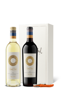 Bottle of Sauvignon Blanc and bottle of Cabernet Sauvignon side by side with an orange wine opener in front of a cream gift box