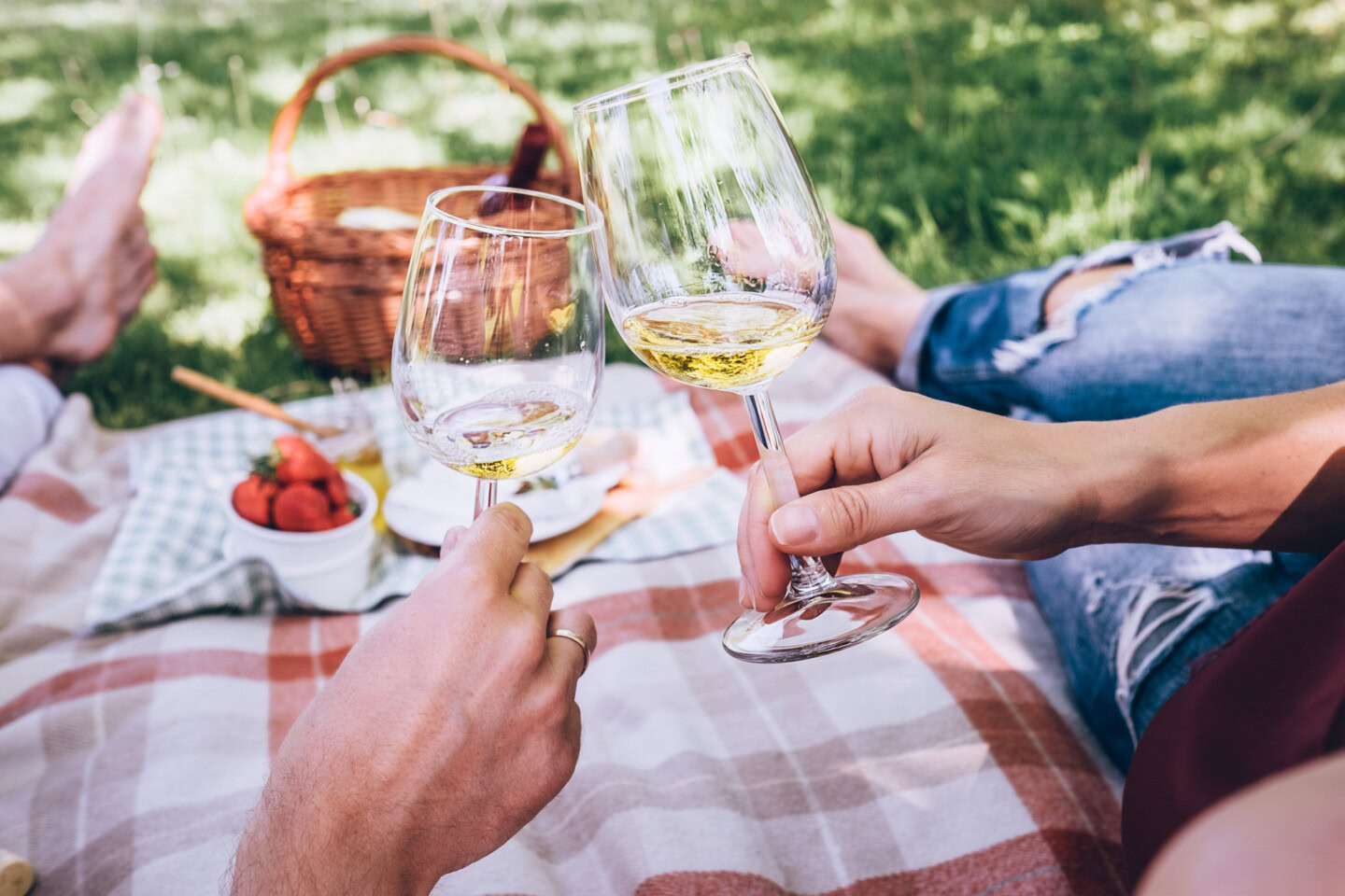 Enjoy a casual outdoor wine tasting with friends at Round Pond Estate, featuring glasses of white wine, a picnic blanket, and.