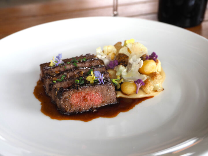Roasted Ribeye A sliced ribeye on a plate with juices.
