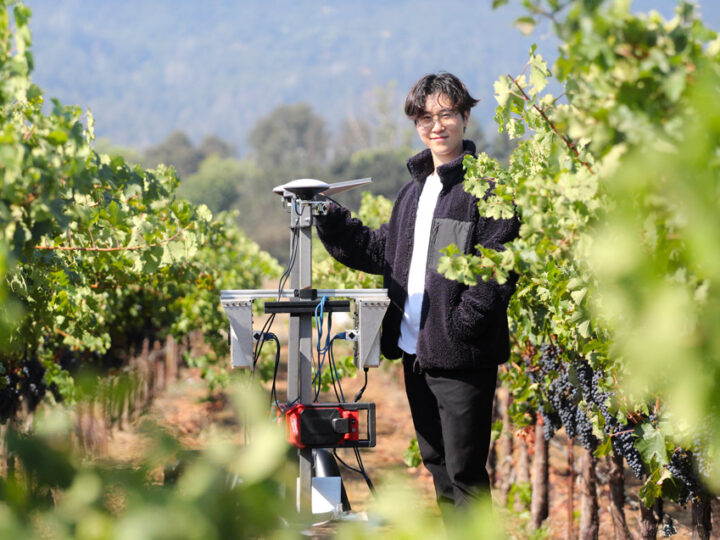 Agricultural robotics in Napa Valley vineyards — Budbreak founder Jonathan Moon stands with Emma, an AI vineyard robot at Round Pond Estate, showcasing sustainable winegrowing technology.