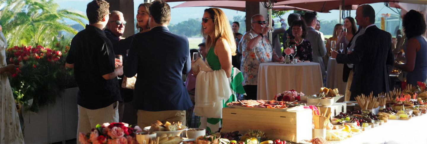 Elegant outdoor garden party at Round Pond Estate with guests enjoying food and drinks.