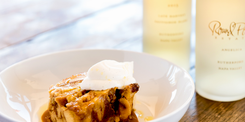 Delicious apple bread pudding topped with whipped cream, served at Round Pond Estate.