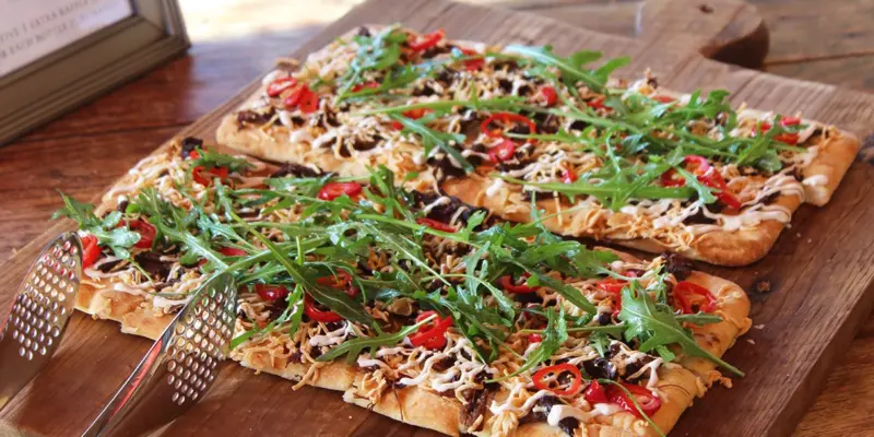 Braised Shortrib Flatbread with arugula and red peppers.