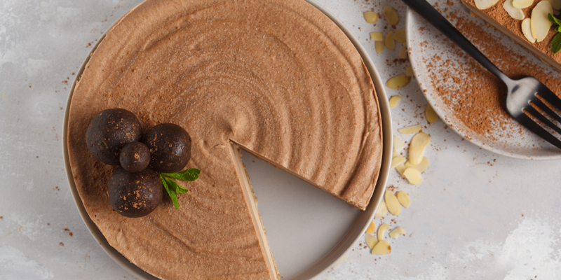 Delicious chocolate mousse pie with a smooth, creamy texture and a graham cracker crust, garnished with chocolate balls and m.