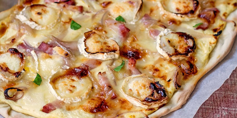 Delicious grilled chicken flatbread with melted cheese and fresh herbs.