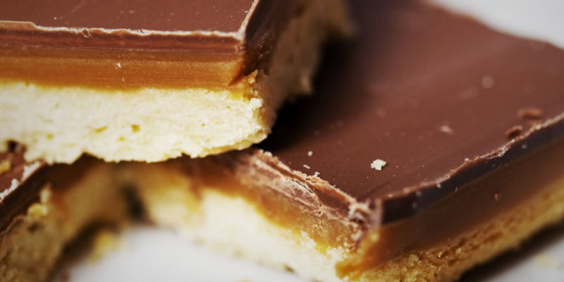 Delicious chocolate caramel bars with a layered texture of rich chocolate, gooey caramel, and buttery cookie crust.